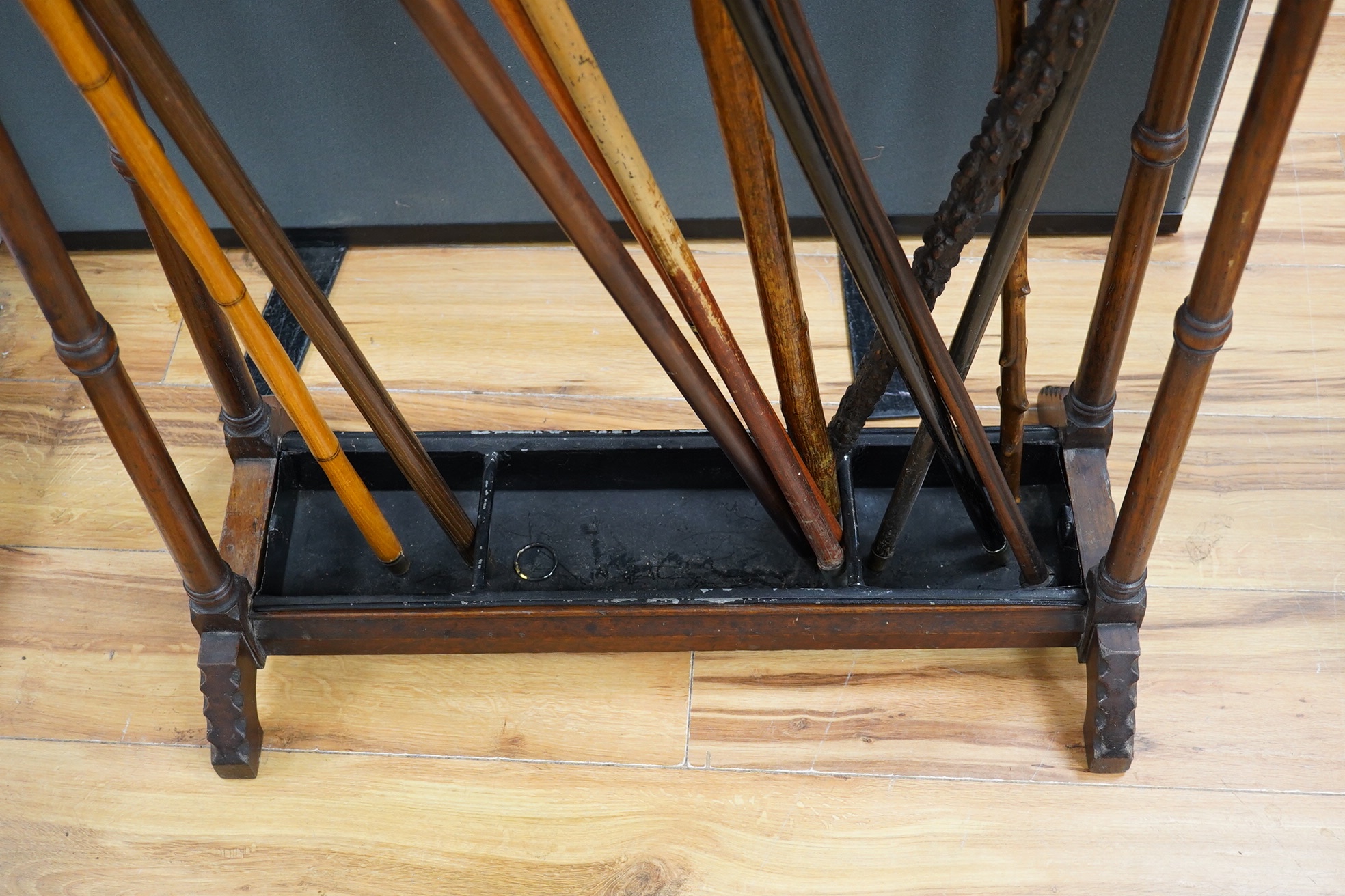 An Arts & Crafts oak umbrella stand and various walking sticks including two silver mounted. Condition - varies